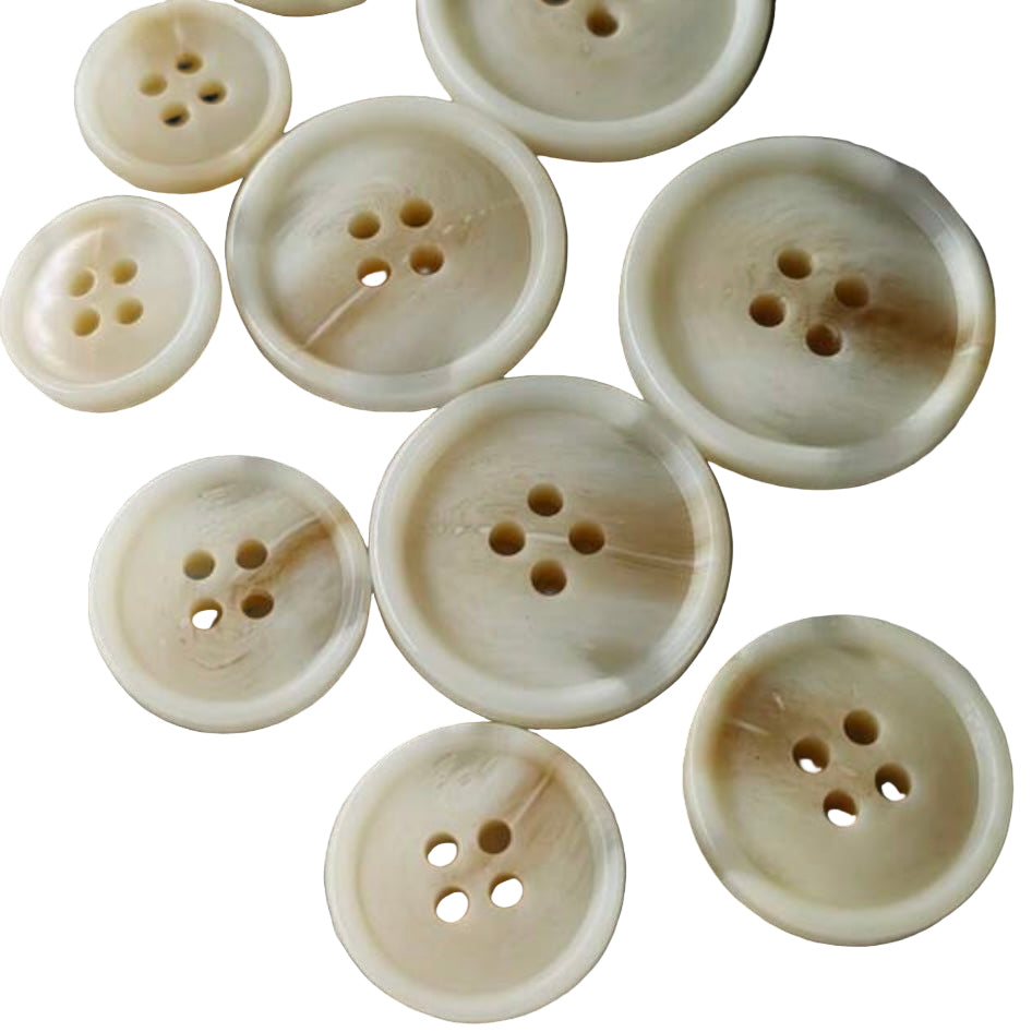 Beige buttons with brown spots on a white background