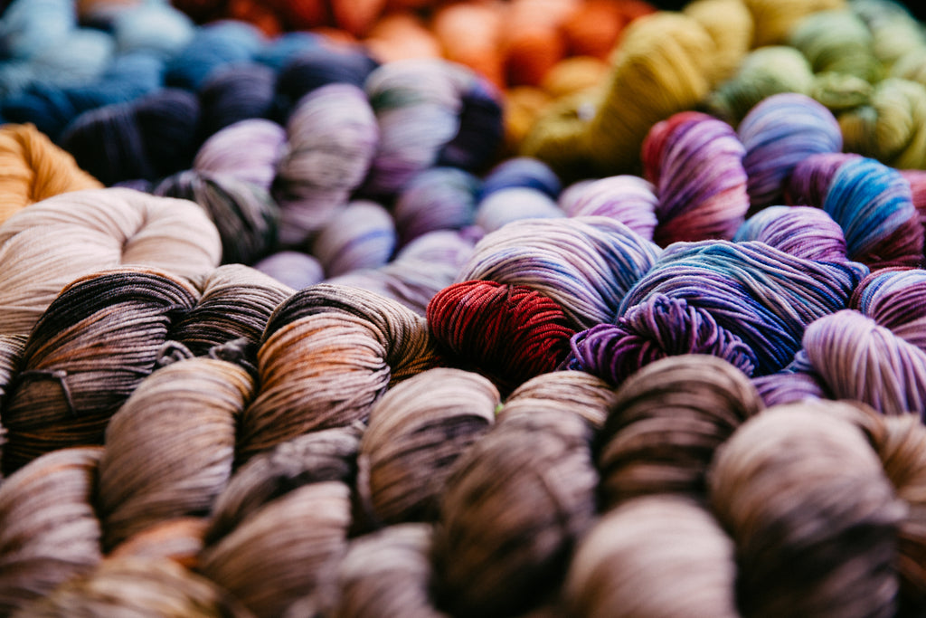 Brightly coloured array of yarn skeins